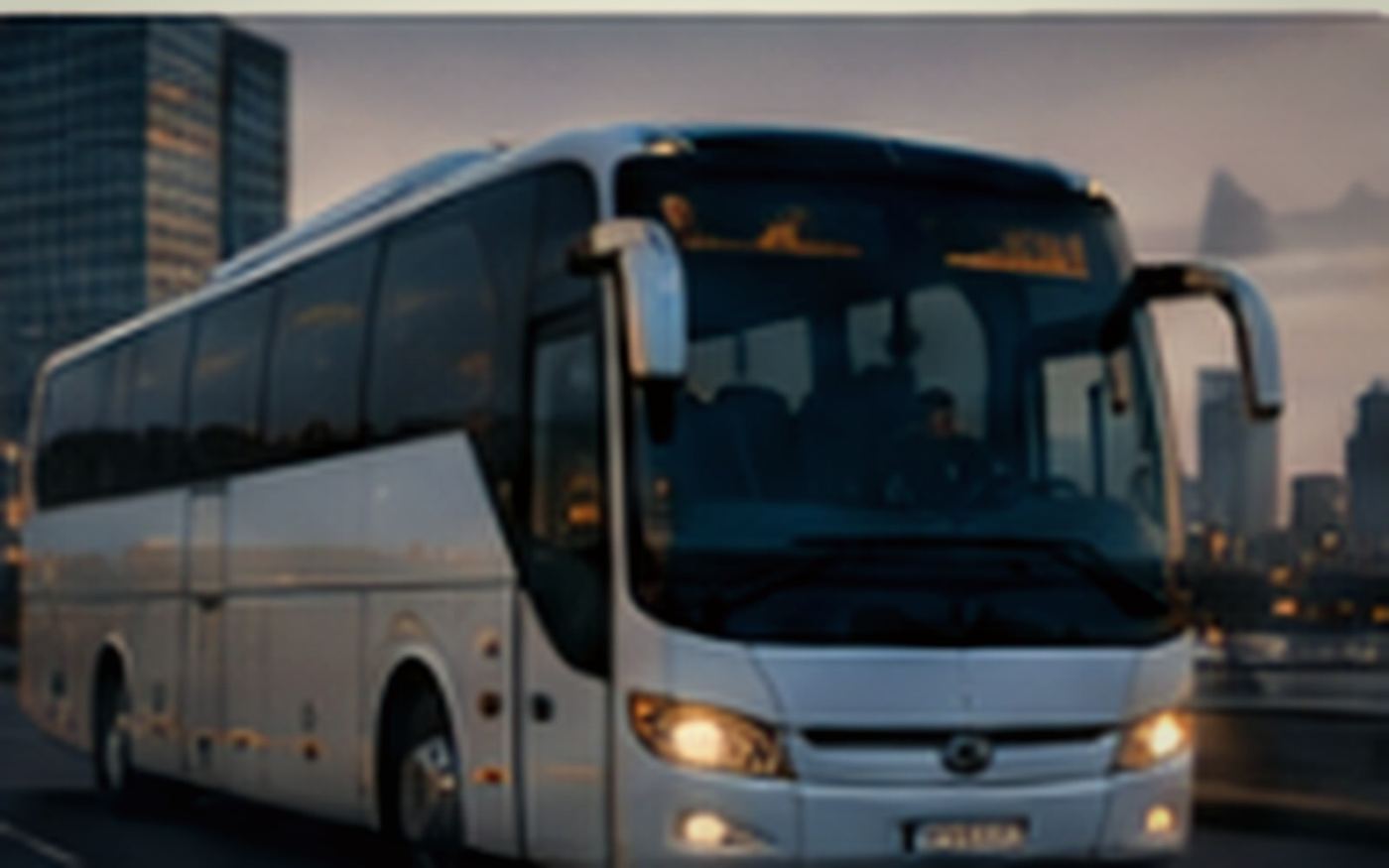 Coach bus on an urban road at dusk